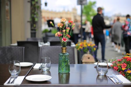 Served table in summer cafe with flowersの写真素材