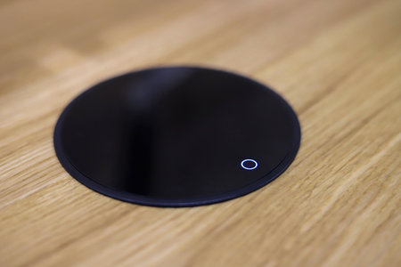 Wireless phone charger integrated in the desk close-up