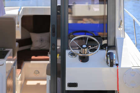 Cockpit modern motor boat with steering wheel and throttle controlの写真素材