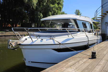 Luxury motor boat moored near the pier in the harborの写真素材