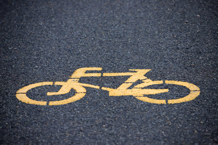 Bike lane sign painted on asphalt close-up