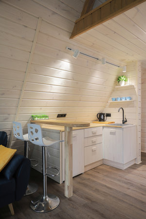 Modern cozy little kitchen interior in a wooden houseの写真素材