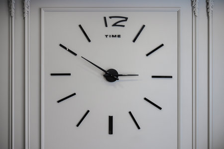 Wall clock with roman numerals on the gray wallの写真素材