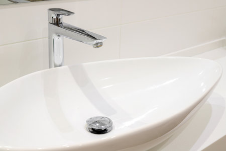 Modern white bathroom sink with faucet close-upの写真素材
