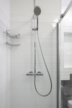 Shower in the bright shower room interiorの写真素材