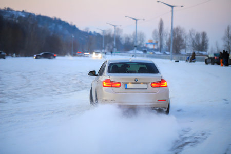 Vyshgorod, Ukraine - 16 january, 2021: Sedan BMW car drifting on the snowのeditorial素材