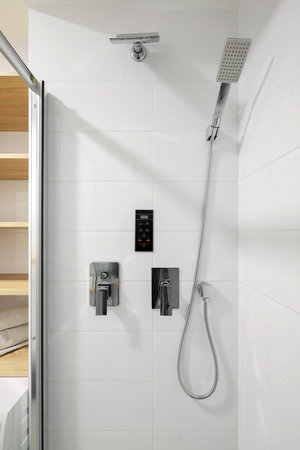 Modern chrome shower in the white shower room interior