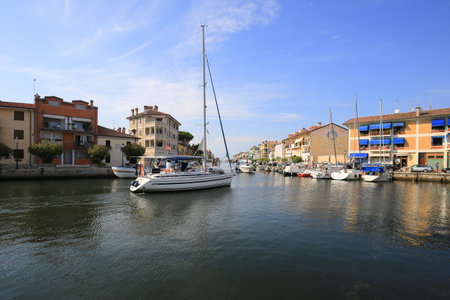 Grado, Italy - 20 July, 2019: Sailing yachts and boats in the water canal in Grado cityのeditorial素材
