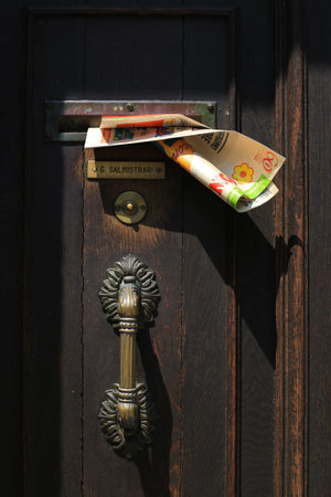 Venice, Italy - July 21, 2019: Advertising newspaper from the supermarket stuck in the door in Venice in Italyのeditorial素材