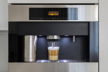 Built-in fully automatic coffee machine in kitchen furnitureの写真素材