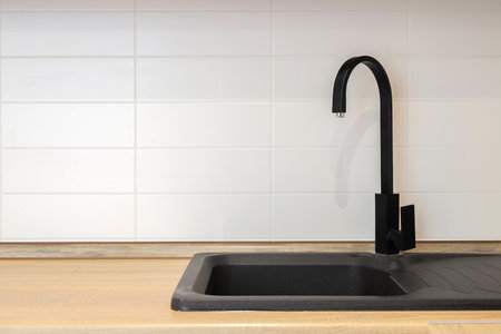 Faucet with granite sink in the kitchen interiorの写真素材
