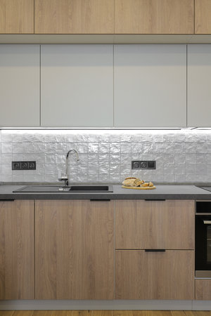 Faucet and granite sink in the modern kitchen furnitureの写真素材