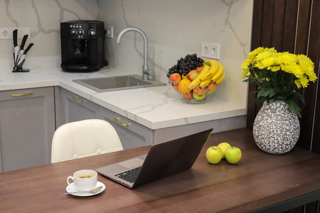Laptop on the table in modern kitchen interiorの写真素材