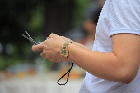 A man using remote control of the drone close-up