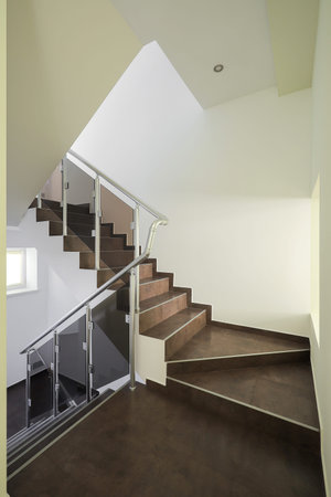 Staircase with brown tiles and light walls inside the house interiorの写真素材