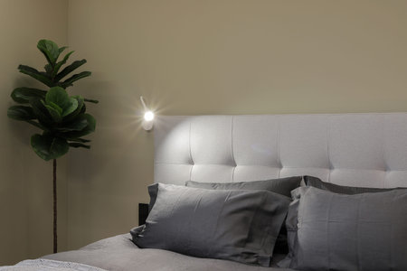 Two pillows on the bed and a night light in the bedroom