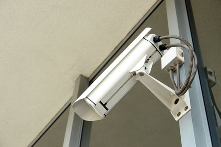 Security cctv camera fixed to office window frame