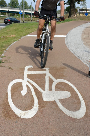 Cyclist riding a bicycle on bike route
