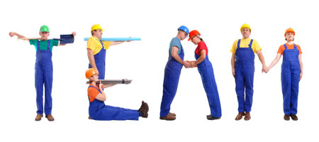 Group of young people wearing different color uniforms and hard hats forming Team word - isolated on white backgroundの写真素材