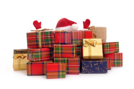 Santa claus overwhelmed by pile of christmas presents over white backgroundの写真素材