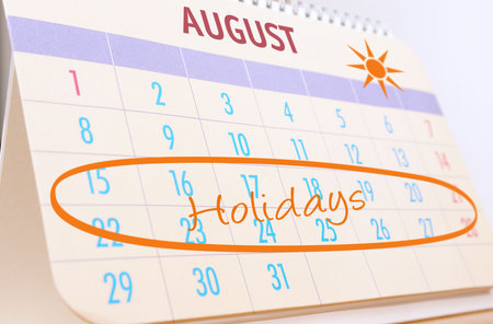 Desktop calendar showing August month with highlighted planned summer holidays