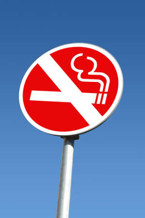 No smoking signpost over blue skyの写真素材