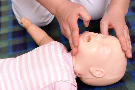  dummy first aid demonstration series - First aid instructor showing how to position  head before proceeding to mouth-to-mouth resuscitationの写真素材