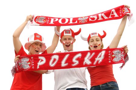 Three young Polish soccer fans dressed in Polish national color t-shirts, caps and scarfs cheering on over white backgroundの写真素材