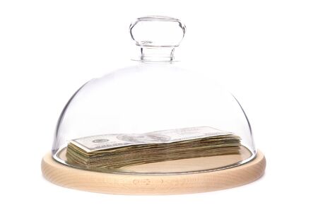 100 US dollar banknotes under bell jar over white background の写真素材