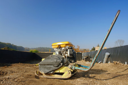 Soil compacting machine inside a house foundation