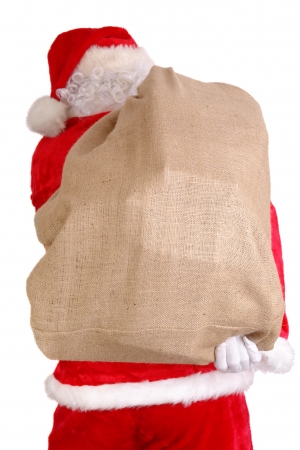 Santa Claus carrying big sack on his back full of christmas presentsの写真素材
