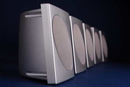 Row of silver loudspeakers over dark blue backgroundの写真素材