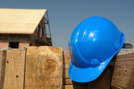 Blue helmet affixed to the wooden shuttering wallの写真素材