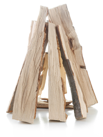 Chopped beechwood logs arranged into triangle prism shot on whiteの写真素材