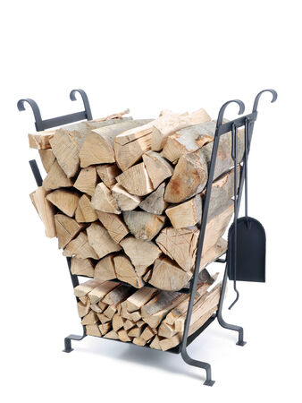 Black firewood metal stand loaded with chopped beechwood logs shot on white backgroundの写真素材