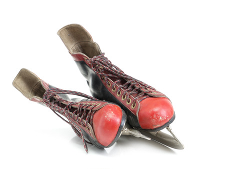 Old black and red hockey skates shot on white backgroundの写真素材