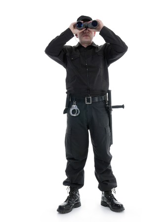 Security man wearing black uniform looking through binocular, shot on whiteの写真素材