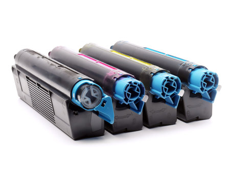 Four used laser printer toner cartridges of Cyan, Magenta, Yellow and black color shot over white...