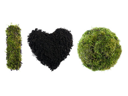I Love Earth acronym made from moss-grown sphere and letter I and soil shaped into heart over white...
