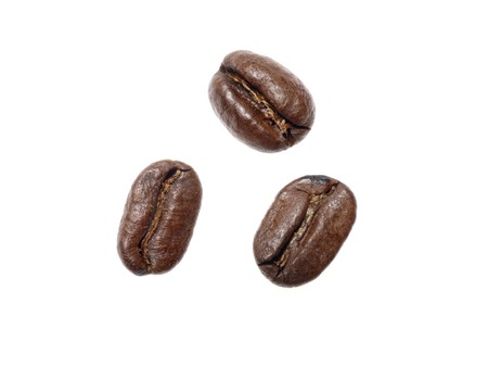 Three coffee beans shot over white backgroundの写真素材