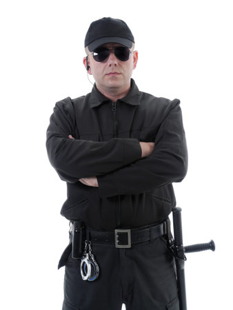 Policeman or security guard wearing black uniform and glasses standing confidently with folded arms,...