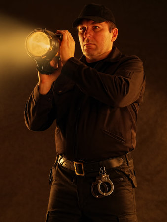 Policeman with lit torch searching the area
