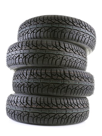 Pile of four winter car tyres shot on whiteの写真素材
