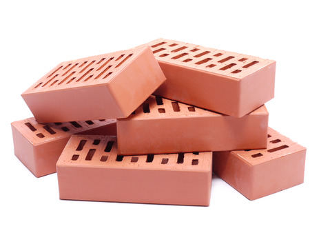 Pile of perforated bricks over white backgroundの写真素材