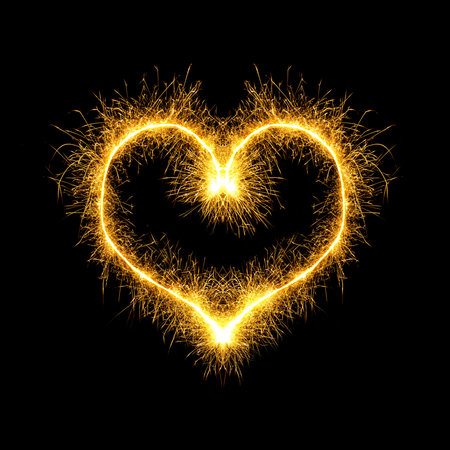 Sparking heart over black backgroundの写真素材
