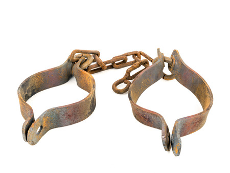 Old rusty handcuffs isolated on whiteの写真素材