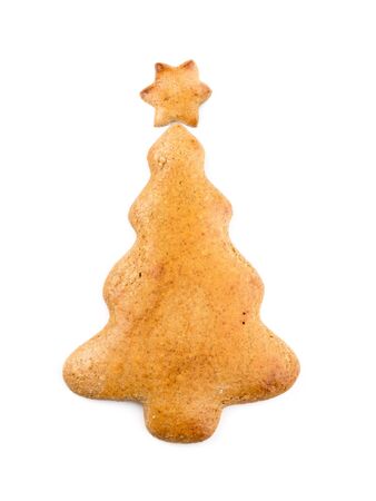 Christmas tree-like gingerbread cookie on white backgroundの写真素材