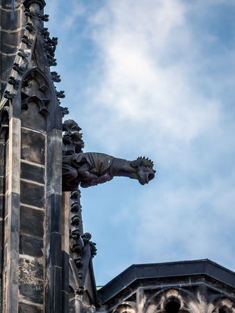 One of many stone demon gargoyles as a part of Metropolitan Cathedral of Saints Vitus, Wenceslaus and Adalbert, Prague Castle, Czech Republicの写真素材