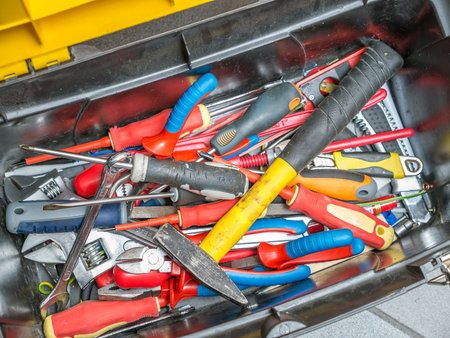Plastic toolbox full of hand tools shot from above