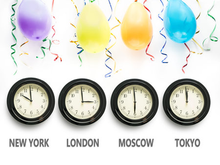 Four wall clocks indicating time zones for New York, London, Moscow and Tokyo with Tokyo time...
